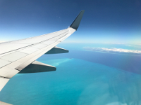 Flying across the Caribbean Sea, admiring the colors of the sea.